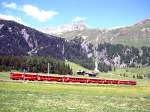 RhB Schnellzug 44 von Davos-Platz nach Landquart vom 20.06.1999 zwischen Davos-Wolfgang und Davos-Laret mit E-Lok Ge 4/4II 612 - A 1255 - B 2329 - B 2296 - B 2450 - A 1226 - D 4213. Hinweis: Fahrt durch ein Blumenmeer. 