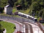 Ge6/6l 414 am 24.8.08 mit einem Hochzeitszug bei der Ausfahrt von Filisur.(fotografiert von einem Baum aus)