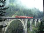 RhB FLIEGENDER RHTIER-Extrazug 3125 von Davos-Platz nach Pontresina vom 30.08.1996 auf Wiesener Viadukt mit Triebwagen ABe 4/4 503 - A 1252 - B 2301 - D 4054.
