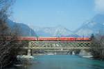 RhB REGIONALZUG 244 von Disentis nach Chur am 17.03.1999 auf der Rheinbrcke bei Reichenau mit E-Lok Ge 6/6II 705 - D 4211 - A 1268 - B 2362 - B 2357 - B 2328. Hinweis: gescanntes Dia
