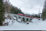 Ge 4/4 III 644 mit RE St. Moritz - Chur am 17. März 2018 auf dem Clix-Viadukt bei Bergün. Die Sesselbahn führt nach Darlux, die Wintersaison ist allerdings bereits beendet und die Sesselbahn deshalb nicht in Betrieb.