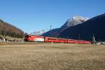 Der Klassiker in Bever: Ge 4/4 III 645 mit dem RE 1140 ausgangs Bever mit dem  Piz D'Esan, dem Piz Mezzaun und der reformierten Kirche im Hintergrund (06.12.2015).