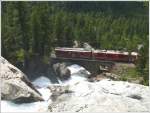 R1650 mit ABe 4/4 II 46 und Gem 4/4 801  Steinbock  auf der Berninabachbrcke bei Morteratsch. (03.07.2009)