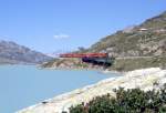 RhB REGIONALZUG 431 von St.Moritz nach Tirano am 21.08.1991 bei Ospizio Bernina auf der Brcke am See mit Triebwagen ABe 4/4 57 - ABe 4/4II 41ff - B - B - B.
