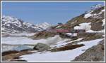 Der BerninaExpress 973 auf der gleichen Brcke mit den beiden ABe 4/4 III 55  Diavolezza  und 56  Corviglia . Im Hintergrund wieder der Piz Ot 3246m und die Station Ospizio Bernina. (15.05.2012)