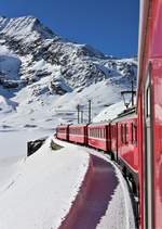 Regio 1625 von St. Moritz nach Tirano unterwegs zwischen Bernina Lagalb und Ospizio Bernina unter grandiosem Wetter. Die Aufnahme entstand am 14. Januar 2018 aus der ABe 4/4 III Nr. 54  Hakone . Dahinter versteckt sich auch die ABe 4/4 III Nr. 53  Tirano . Links sieht man den komplett zugefrorenen Lago Bianco.