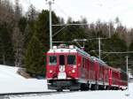 RhB - Triebwagen ABe 4/4 47 und ABe 4/4 43 mir Regio bei Pontresina am 07.04.2010