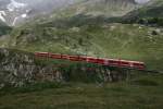 Zug 1632 ist der erste durchgehende Zug Tirano - St. Moritz am Morgen. Mit einem Allegra-Triebzug bespannt, berquert der Zug soeben die Brcke ber den Berninabach bei der Alp Bondo. Am  Reisezugschluss  (es folgen noch einige Gtewagen) luft einer der 10 frisch revidierten B EWIII. Aufnahme am 28.7.2010. 