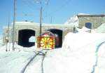 RhB DAMPFSCHNEESCHLEUDERZUG 4421 fr GRAUBNDEN TOURS am 08.02.1997 von Ospizio Bernina nach Lago Bianco km 25,000 bei Rckfahrt an der Depotdurchfahrt von Ospizio Bernina mit Triebwagen ABe 4/4II 48