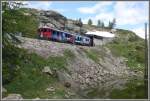 BerninaExpress 973 mit ABe 4/4 III 56  Corviglia  und 53  Tirano  verlassen soeben die Sassal Mason II Galerie oberhalb von Alp Grm. (15.06.2011)