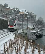 Winter - Schnee im Lavaux ist im Winter eher selten und ziert bei diesem Bild des SBB RABe 523 027 nicht nur St Saphorin im Hintergrund sehr vorteilhaft, sondern auch den Baum rechts im Bild.