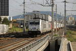 386.007 führt einen Containerzug an der durch Graz Hauptbahnhof donnert.