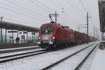 Im dichten Schneefall des 9.12.2020 steht die 1116 048 mit dem KGAG43633 von Bratislava-Petrzalka nach Spielfeld-Straß in Kalsdorf und wartet die Kreuzung mit einem Regionalzug ab.