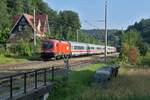 In Durlesbach zieht 1116 271 die Wagen des IC 890, Bregenz - Frankfurt (M) Hbf und die abgebügelte 1116 085 am Zugende durch den Schussentobel bei Kilometer 163.2 (14.07.2022)