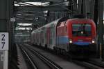 1116 015 der RailCargoHungaria vor einem Pers auf der Wiener Stammstrecke, hier zum sehn vor dem R 2251 von Wien Floridsdorf nach Payerbach-Reichenau auf der Norbahnbrcke; am 04.05.2012