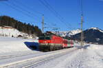 1144 279 mit dem REX 1516 (Salzburg Hbf – Wörgl Hbf) bei Fieberbrunn 9.2.22