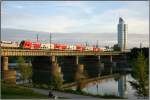 EM-Lok 1116 029 Schweden fhrt mit einem Doppelstockzug ber die Nordbahnbrcke in Wien.Im Hintergrund ist der Millennium Tower zu sehen.