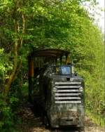 A passenger train is arriving to Pityur-rtje stop on a sunny summer day.
