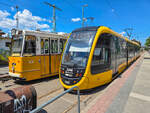 Stra�enbahn Budapest Zug 2246 auf der Linie 49 nach B�csi �t neben Zug 1318 auf der Linie 49 nach De�k Ferenc t�r in Kelenf�ld, 19.06.2026.