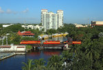 FEC train 123, 2300 Bowden Yard (Jacksonville) - Fort Lauderdale crosses the Tarpon River in Downtown Fort Lauderdale,  22 June 2016.

Traction is provided by 812, 703, 720 & 487