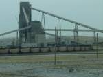 Four trains can be loaded with coal at the same time at this facility. Here 2 are being loaded while one empty goes onto the staging track. It is a Sunday afternoon, so not quite as busy. Nov 2003.