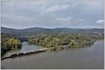 Zwei CSX Loks der Gattung SD-40/45/60 ziehen den Zug beinahe auf Wasserhöhe südwärts unter der Bear Mountain Bridge hindurch.