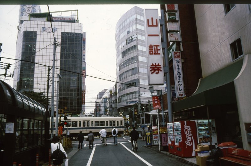 Tokyo S-Bahn, Odakyû-Konzern. Zwei Züge kreuzen sich mitten auf der Strasse der Stadt Machida im Grossraum Tokyo. 9.Oktober 1996.