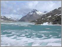 Der Lago Bianco auf dem Berninapass wirkt noch etwas arktisch. Rechts erkennt man die Strecke der RhB und in Bildmitte �ber dem See die Geb�ude von der Station Ospizio Bernina. (08.05.2007)