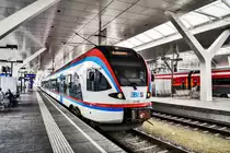 ET 133 fährt als R 3065 nach Straßwalchen, aus Salzburg Hbf aus.
Aufgenommen am 26.7.2018.