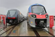  Rock  und  Pop  vereint:
ETR 521, Zug 03 (Hitachi Caravaggio), vermarktet als  Rock , und ETR 103 001 (Alstom Coradia Stream), vermarktet als  Pop , der Trenitalia (Ferrovie dello Stato Italiane | FS) stehen auf dem Gleis- und Freigelände der Messe Berlin anlässlich des  Tags des Eisenbahners  im Rahmen der Publikumstage zur InnoTrans 2018.
Weitere Informationen zu den Fahrzeugen:
https://www.virtualmarket.innotrans.de/de/Caravaggio,dct5-548
https://www.virtualmarket.innotrans.de/de/Coradia-Stream,dct5-446
[23.9.2018 | 15:09 Uhr]

Mit diesem Bild endet mein Rundgang auf der InnoTrans 2018. Ich bin gespannt auf die nächste Messe im kommenden Jahr.
