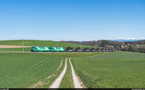 MBC Ge 4/4 22 und 21 mit einem schweren Rollbock-Zug bestehend aus 11 Slmnnps beladen mit Panzern der Schweizer Armee von Morges nach Bière-Casernes am 8. April 2021 bei Ballens.