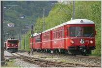 Die S8 mit Be 4/4 und Steuerwagen 1716 �berholt die Ge 6/6 II 702  Curia  bei Landquart Ried. (30.04.2009)