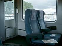 Im Gro�raum eines Bvmz-Wagens in Mischbauweise findet man vorwiegend Reihensitze in Zweierbestuhlung vor. Vier Sitzpl�tze mit Tisch findet man nur in der Mitte des Wagens. Die T�r links im Bild f�hrt zu zwei von insgesamt f�nf 6er-Abteilen. (25.07.2009)