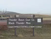 A Burlington Northern SD70MAC heads past the sign at the Thunder Basin Coal Co. near Wright, Wyoming, Nov 2003.