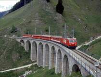 MGB exFO GLACIE-EXPRESS B 902 von Zermatt nach Chur am 28.05.1992 auf Bugnei-Viadukt mit E-Lok HGe 4/4II 106 - B - BVZ B - RhB B - A.

