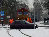 DE 669 der HGK muss mit den mit Heiz�l bef�llten Kesselwagen am 03.12.2010 an einem unbeschrankten und nicht mit Lichtzeichen ausgestatteten Bahn�bergang solange mit der �berfahrt warten, bis zwei Bahnmitarbeiter den �bergang gesichert haben. DE 669 befindet sich auf der Fahrt von Friedrichshafen Gbf ins Industriegebiet Friedrichshafen, um einen Heiz�lh�ndler zu beliefern.