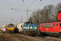 W�rend links die TXL 266 038 auf Weiterfahrt nach Flandersbach wartet �berhollt Niag 4 mit ihrem Zug nach D�sseldorf-Reisholz.Desweiteren f�hrt 155 268 mit einem G�terzug Richtung Duisburg.Aufgenommen am 4.3.11 in Ratingen-Lintorf