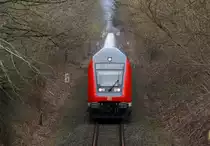 Eine von 218 330-9 geschobene Dostogarnitur als RE nach Kiel Hbf am 13.03.2011 in Timmdorf.