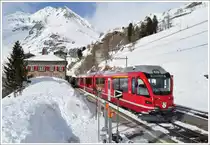 R1633 nach Tirano mit ABe 8/12 3503  Carlo Janka  mit G�terlast legt einen Halt ein in Alp Gr�m. (22.02.2011)