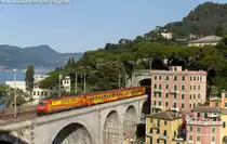 The E484.091 of Arenaways hauls the IC train n. 13980/13981 fron Santhi� to Livorno Centrale, here in Zoagli. (June 22, 2011)