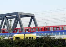 Hamburger Impressionen: Farbenvielfalt im Nahverkehr. Ein S-Bahn-Zug Richtung Harburg hinter einem Metronom-Zug Richtung Hauptbahnhof. 3.10.2011