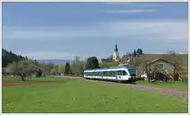 5063 008 am 17.4.2012 als S6 (R 4370) von Wies �ber Hengsberg nach Graz bei der Ausfahrt aus der Haltestelle Wies-Markt mit Blick auf die dortige Pfarrkirche.