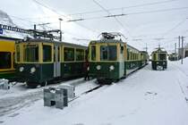 3 dreiteilige BDeh 4/4 Pendelz�ge warten in Kleine Scheidegg auf den n�chsten Einsatz. Der starke Schneefall hat nun nachgelassen, und die Sonne dr�ckt ein bisschen durch die Wolkendecke. Die Pendel sind, v. l. n. r: Pendel 110, 109 und 107, 16.05.2012.