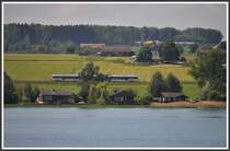 Ein Thurbo GTW zwischen Romanshorn und Kreuzlingen, aufgenommen von einem Bodenseeschiff. (20.05.2012)