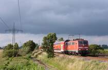 111 137-6 fuhr am 17.07.2012 mit einem RE von Emden nach Mnster, hier sdlich von Leer.
