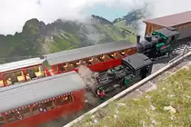 Bereits Pause auf Rothorn Kulm. Im Vordergrund Salon Rouge (1936) mit Lok 5 (ex WAB, 1891), dahinter Lok 16 (1992) mit B 12 (1892) und einem B 4 (? Nr. nicht sichtbar, ab 1973) Dirrengrind und Brienzersee zeitweise sichtbar. Mit dem Wetter hatten wir noch Gl�ck, 16. Juli 2012, 12:28
