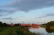 Eine 146.1 fuhr am 01.09.2012 mit einem RE von Norddeich Mole nach Hannover, hier �berquert sie den sauteler Kanal bei Neermoor.
