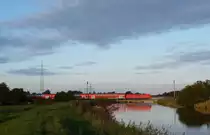 Eine 146.1 fuhr am 01.09.2012 mit einem RE von Norddeich Mole nach Hannover, hier �berquert sie den sauteler Kanal bei Neermoor.