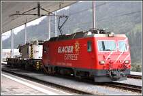 HGe 4/4 II 106  San Gottardo  wartet mit dem Kirow Schienenkran auf die Abfahrt in Disentis. Der Kirow Kran verkehrt normalerweise auf dem Netz der RhB. F�r die Fahrt �ber die Zahnstangenstrecke ist der Kran zus�tzlich mit vier Transportb�ndern mit der Lok verbunden und gesichert worden. (25.09.2012)