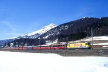 RhB Schnellzug 550 von St.Moritz nach Chur am 12.03.2000 zwischen Samedan und Bever mit E-Lok Ge 4/4 III 647 - B 2461 - B 2494 - A 1273 - WR 3810 - A(WR-S) 1223 - A 1282 - A 1240 - B 2491 - B 2364 - B 2443 - D 4217. Hinweis: gescanntes Dia
